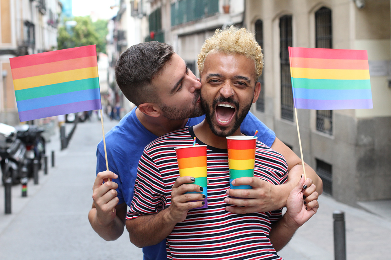 Cute gay couple partying outdoors